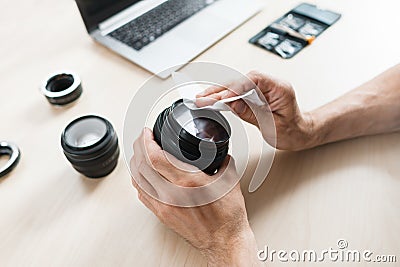 Camera lens cleaning with wet wipe, close-up Stock Photo