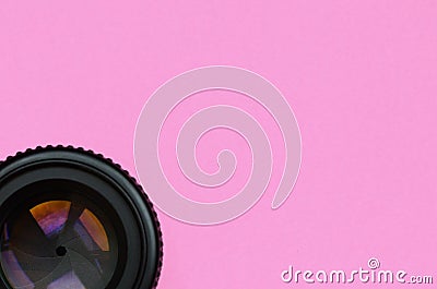 Camera lens with a closed aperture lie on texture background of fashion pastel pink color paper in minimal concept Stock Photo