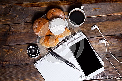 Camera lens with croissants and coffee next to notebook Stock Photo