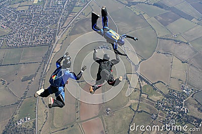 Camera man filming to skydivers Stock Photo