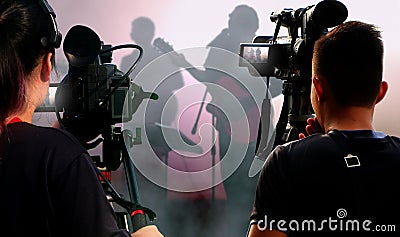 Camera operators working with video equipment at concert Editorial Stock Photo
