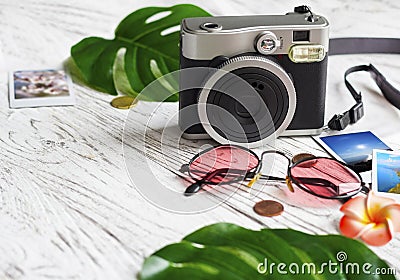 Camera, photo, coins, sunglasses, leaves Stock Photo