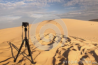 Camera on a tripod at sand dunes Stock Photo