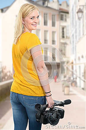 Camera woman holding his professional camcorder in the street Stock Photo