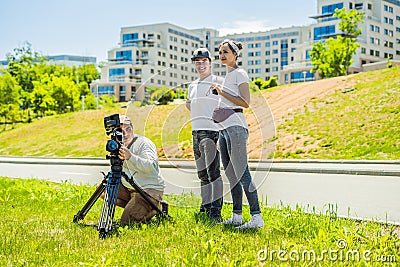 Cameraman, director and asistant on a cinema, commercial production exterior set Stock Photo