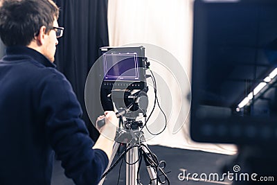 Cameraman operates a film camera, broadcasting studio Editorial Stock Photo