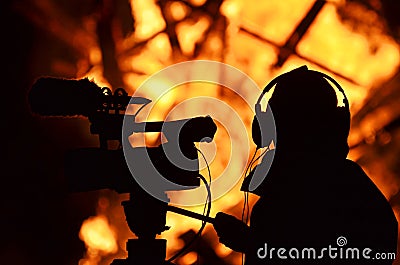 Cameraman reporter journalist filming building on fire flames Stock Photo