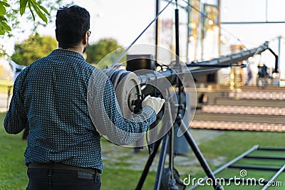 Cameraman working in a broadcast television virtual outdoors tv studio Stock Photo