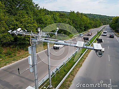 Cameras and speed control radars along a busy highway monitor and record speeding violations. Stock Photo