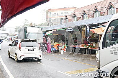 CAMERON HIGHLAND, MALAYSIA - FEBRUARY 2019 : Tourists shop in the local market in Raining Season in Cameron Highlands. Cameron Editorial Stock Photo