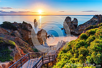 Camilo Beach (Praia do Camilo) at Algarve, Portugal with turquoise sea in background. Wooden footbridge to beach Praia Stock Photo