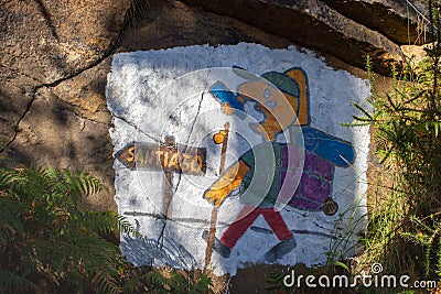 Camino de Santiago sign with drawing of unknown pilgrim. Pilgrimage concept. Funny pilgrim drawing image on rock. Editorial Stock Photo