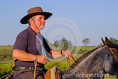 CAMINOS, CANELONES, URUGUAY, OCT 7, 2018: Gaucho riding on a horse at a Criolla Festival in Uruguay Editorial Stock Photo