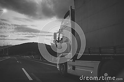 Camion, van rides along the road in evening, rear view. argo van, truck, kamion transports goods or items between Stock Photo