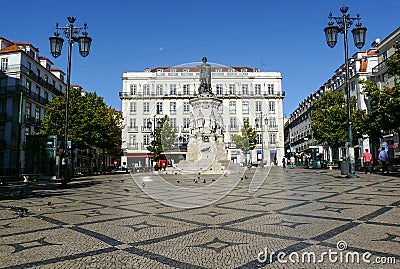 Camoes square with typical portuguese cobblestone hand-made mosaic pavement and monumental statue of 16th century epic poet Luis Editorial Stock Photo