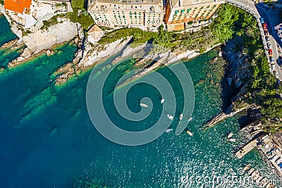 Camogli rocky coast aerial view. Boats and yachts moored near harbor with green water. Stock Photo