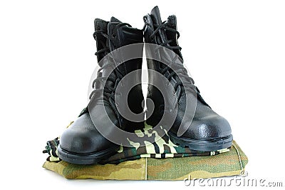 Camouflage uniform and two army boots. Stock Photo