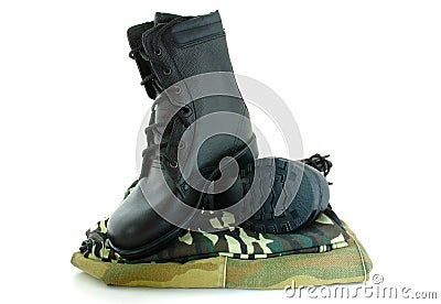 Camouflage uniform and two army boots. Stock Photo
