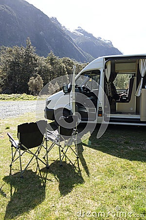 Camp chairs outside a campervan in the Fjordland National Park Stock Photo