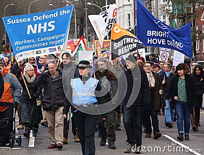 Campaigners march through Brighton, UK in protest against the planned cuts to public sector services. The march was organised by B Editorial Stock Photo