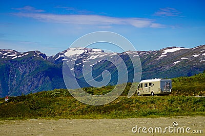 Camper car on road in norwegian mountains Stock Photo