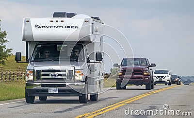 A camper RV trailer at a busy highway during a long weekend with lots of traffic Editorial Stock Photo