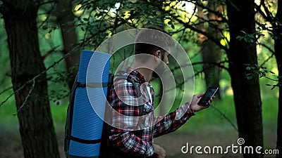 Camper searching for mobile phone signal after lost in woods, bad connection Stock Photo