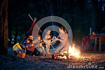 Campers family on evening in forest Stock Photo