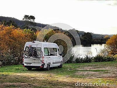 Campervan near water edge at a recreational camping area in New Zealand Editorial Stock Photo