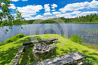 Campfire place on the lake coast Stock Photo