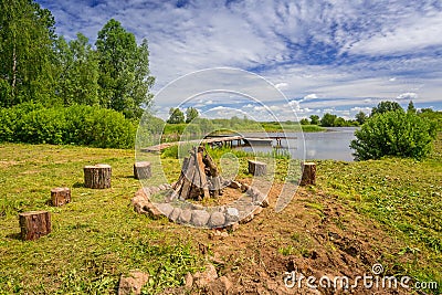 Campfire place at the lake in summer time Stock Photo