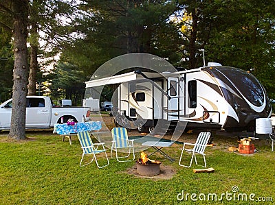 Camping on the campground with travel trailer Stock Photo