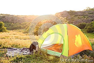 Camping gear and tourist tent in wilderness Stock Photo