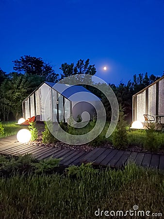Camping, glamping in the evening, blue night sky, moon shines, backlight lantern Stock Photo