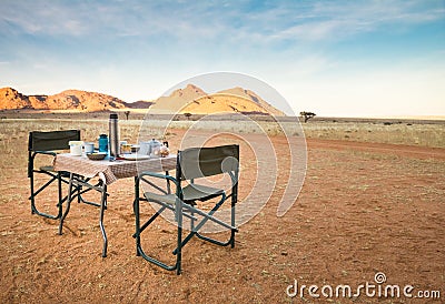 Camping table and chairs in the desert. Great view. Sunrise. Stock Photo