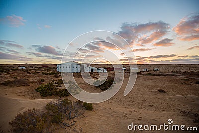 Camping tents and campfire in the middle of the Moroccan Sahara Stock Photo