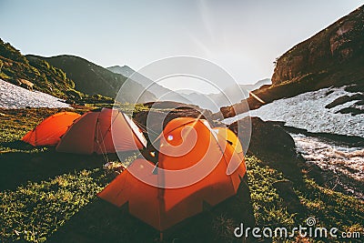 Camping tents in mountains morning sun landscape Stock Photo