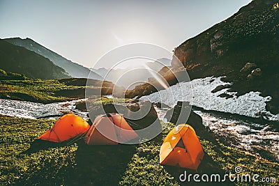 Camping tents in mountains morning sun landscape Stock Photo