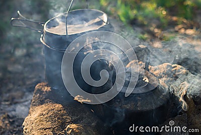 Camping and tourist equipment. For breakfast and dinner on a hike. Cooking food at the stake. Crockery in the campaign. Meal at th Stock Photo