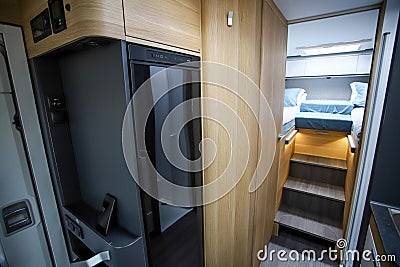 Camping in trailer, rv kitchen and bedroom, nobody. Mobile kitchen and wardrobe in the camper. Life in a mobile home. Stock Photo