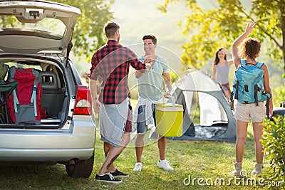 Camping trip, Young happy people say hello arrived friends Stock Photo