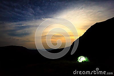 Camping under stars in mountains Stock Photo