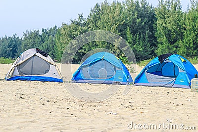 Campsite on beach. Tents on sea beach with sky and green background. Tent on the beach, Bay area day trip activities. Editorial Stock Photo