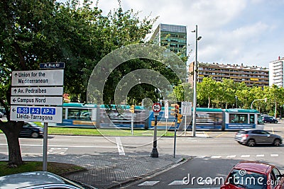 Campus Nord sign post with moving tram behind in Barcelona Editorial Stock Photo