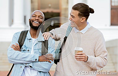 Campus, students laugh and university friends with college education, funny conversation or studying support together Stock Photo