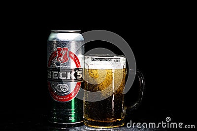 Can of Beck`s or Becks beer and beer glass on dark background. Illustrative editorial photo shot in Bucharest, Romania, 2021 Editorial Stock Photo