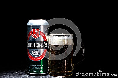 Can of Beck`s or Becks beer and beer glass on dark background. Illustrative editorial photo shot in Bucharest, Romania, 2021 Editorial Stock Photo