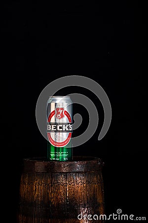 Can of Becks beer on beer barrel with dark background. Illustrative editorial photo Bucharest, Romania, 2021 Editorial Stock Photo