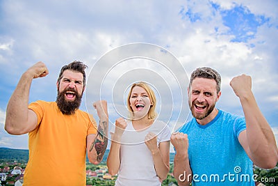 We can do it. Celebrate success. Ways to build successful team. Threesome stand happy with raised fists. Behaviors of Stock Photo