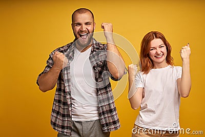 We can do it. Successful team of coworkers clench fists, celebrate victory, exclaim positively, looks confident, have cheerful Stock Photo